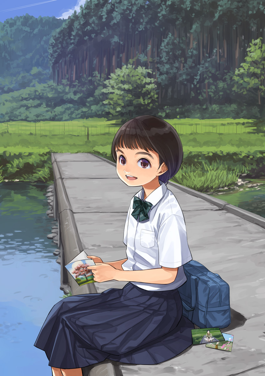 1girl bag black_hair blue_bag blue_skirt blue_sky bow bowtie bridge brown_eyes card cloud collared_shirt contrail day dress_shirt feet_out_of_frame fence foliage foot_dangle forest from_side grass green_bow green_bowtie highres holding holding_card looking_at_viewer looking_to_the_side nature on_ground open_mouth original otsu_natsu outdoors photo_(object) pleated_skirt river scenery school_bag school_uniform shirt short_hair short_sleeves sitting skirt sky smile solo teeth tree upper_teeth_only water white_shirt