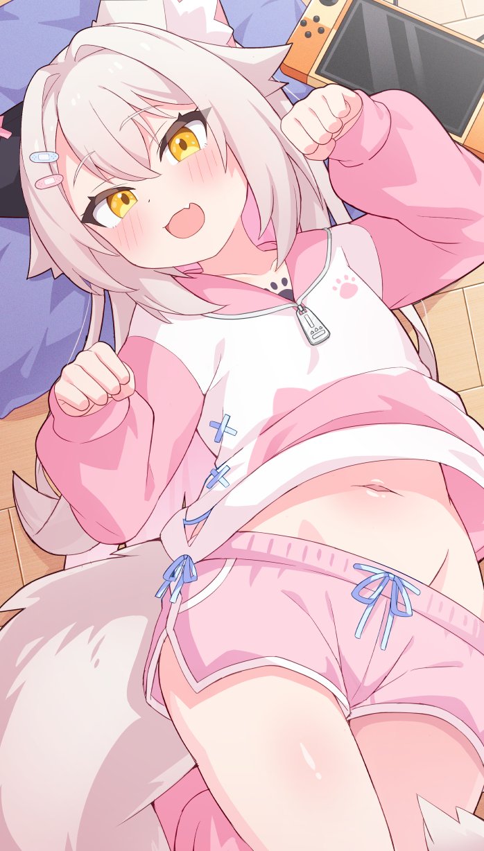 1girl :d animal_ears blush cat_ears cat_girl cat_tail clothes_lift dolphin_shorts fang handheld_game_console highres hip_bones hood hood_down hoodie hoodie_lift long_hair long_sleeves looking_at_viewer navel open_mouth original pillow pink_hoodie pink_shorts shorts skin_fang smile solo stomach tail ug_(nekonekodou) white_hoodie yellow_eyes