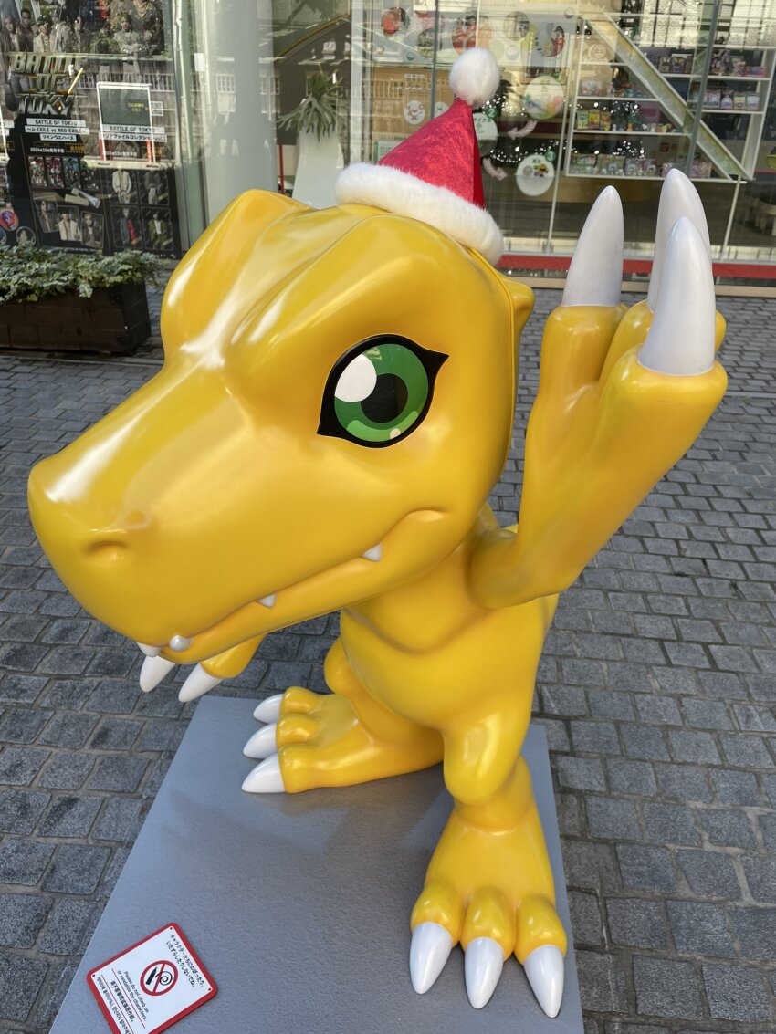 christmas claws digimon digimon_(creature) green_eyes hat photo_(medium) santaagumon sharp_teeth solo teeth