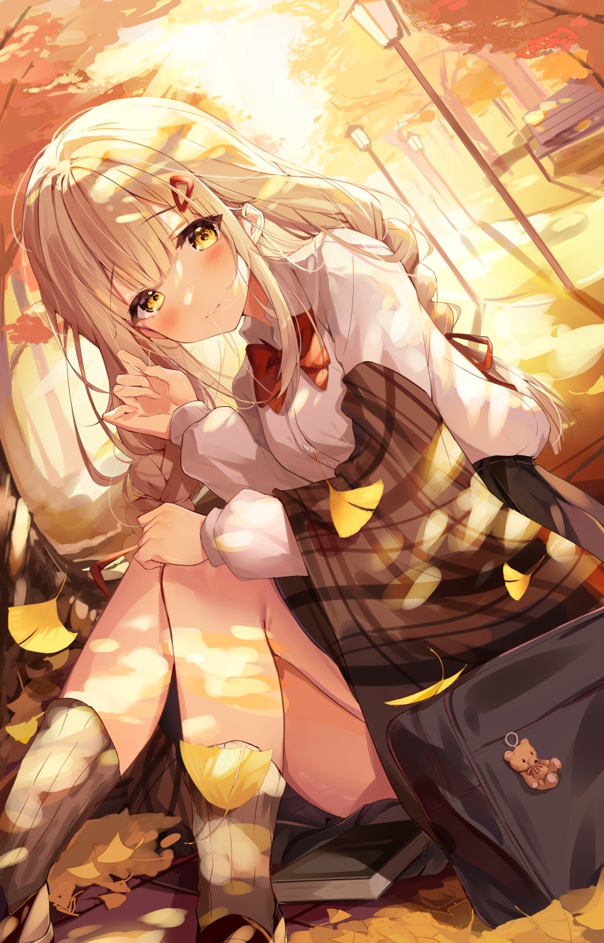 1girl absurdres animal_charm autumn autumn_leaves bag blonde_hair blush bow bowtie braid brown_socks chenyan commentary_request hair_ornament hairclip highres leaf long_hair long_sleeves looking_at_viewer otonari_no_tenshi-sama_ni_itsu_no_mani_ka_dame_ningen_ni_sarete_ita_ken red_bow red_bowtie school_bag school_uniform shiina_mahiru_(otonari_no_tenshi-sama) shirt sidelocks sitting skirt socks solo twin_braids white_shirt yellow_eyes