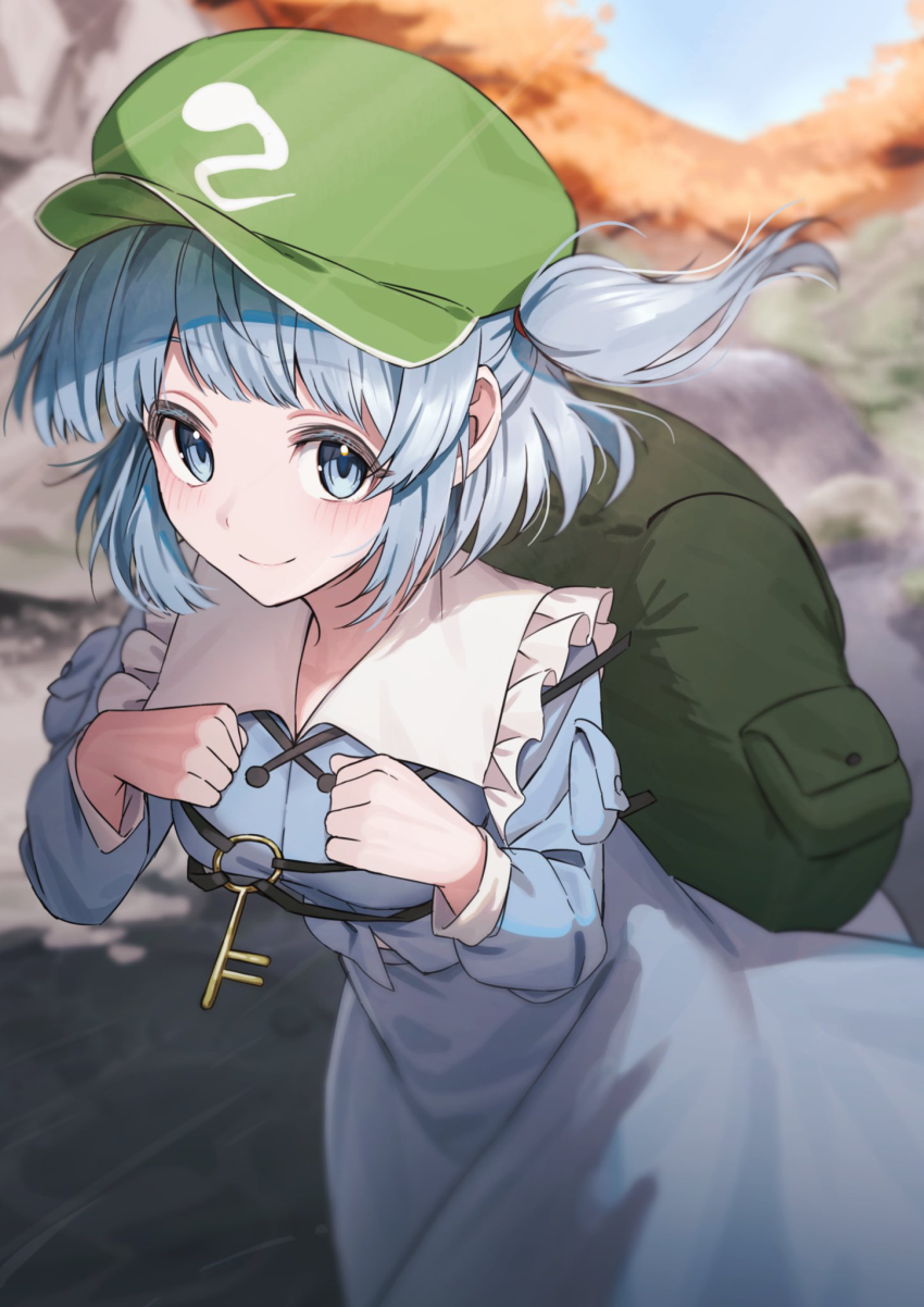 1girl backpack bag blue_bag blue_eyes blue_hair blue_hat blue_shirt blue_skirt closed_mouth collared_shirt commentary_request cowboy_shot flat_cap frilled_shirt_collar frills green_hat hands_up hat highres kawashiro_nitori key long_sleeves looking_at_viewer one_side_up outdoors shirt short_hair skirt smile solo touhou wanko_sora