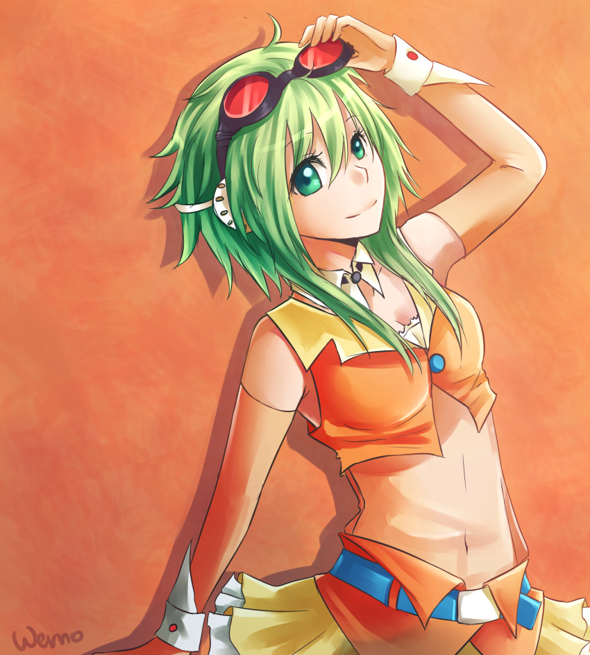 1girl behind-the-head_headphones breasts cleavage commentary cropped_vest detached_collar gloves goggles goggles_on_head green_eyes green_hair gumi hand_up headphones highres looking_at_viewer navel orange_background short_hair_with_long_locks skirt smile solo vest vocaloid werno wrist_cuffs