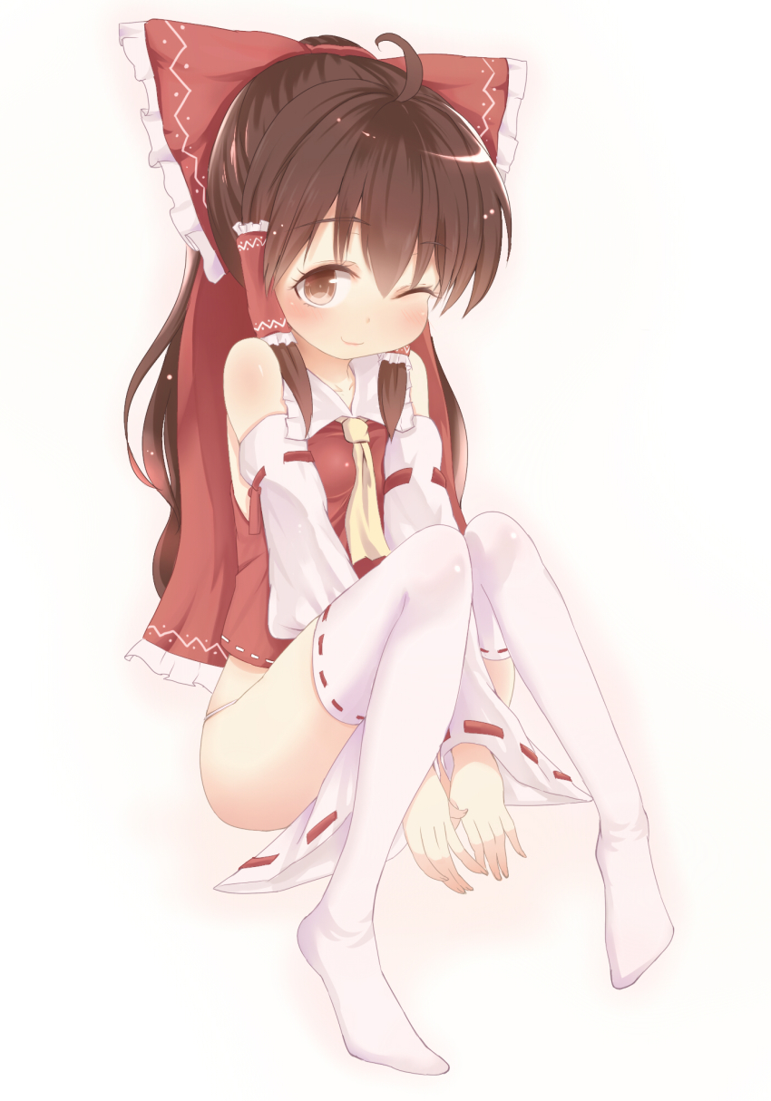 1girl ascot between_legs blush bow brown_eyes brown_hair covering_privates detached_sleeves erio_patrol female_focus hair_bow hair_tubes hakurei_reimu highres knees_together_feet_apart long_hair looking_at_viewer no_pants no_shoes one_eye_closed sidelocks sitting smile solo thighhighs touhou v_arms white_thighhighs