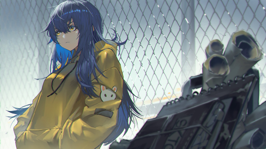 1girl blue_hair book chain-link_fence closed_mouth commentary english_commentary fence hair_between_eyes hands_in_pocket highres hood hoodie leaning_back long_hair original outdoors paper rabbit_ornament solo standing xleontan yellow_eyes yellow_hoodie