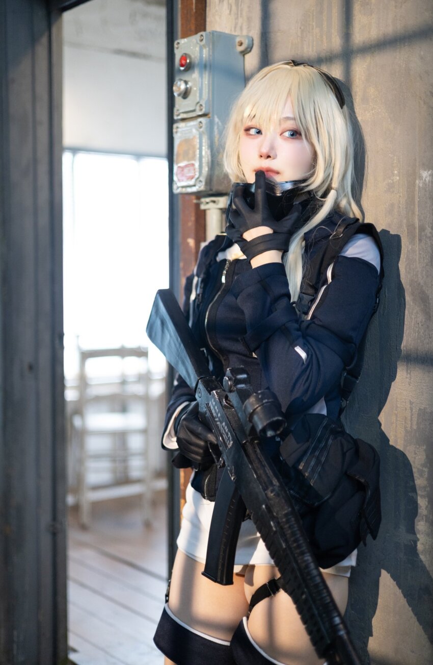 1girl ammunition_pouch an-94 an-94_(girls&#039;_frontline) assault_rifle black_gloves black_shirt blonde_hair blue_eyes chair cosplay_photo girls&#039;_frontline gloves gun hair_between_eyes highres holding holding_gun holding_weapon indoors long_hair mask mask_around_neck myangg11 photo_(medium) pouch real_life rifle shirt shorts skindentation solo thigh_strap weapon white_shorts wooden_floor