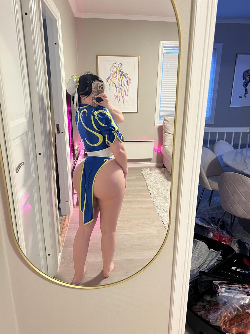 1girl absurdres ass barefoot blue_dress capcom china_dress chinese_clothes chun-li chun-li_(cosplay) cosplay cosplay_photo double_bun dress female_focus hair_bun highres huge_ass indoors photo_(medium) real_life selfie solo street_fighter thick_thighs thighs twerking_lilly