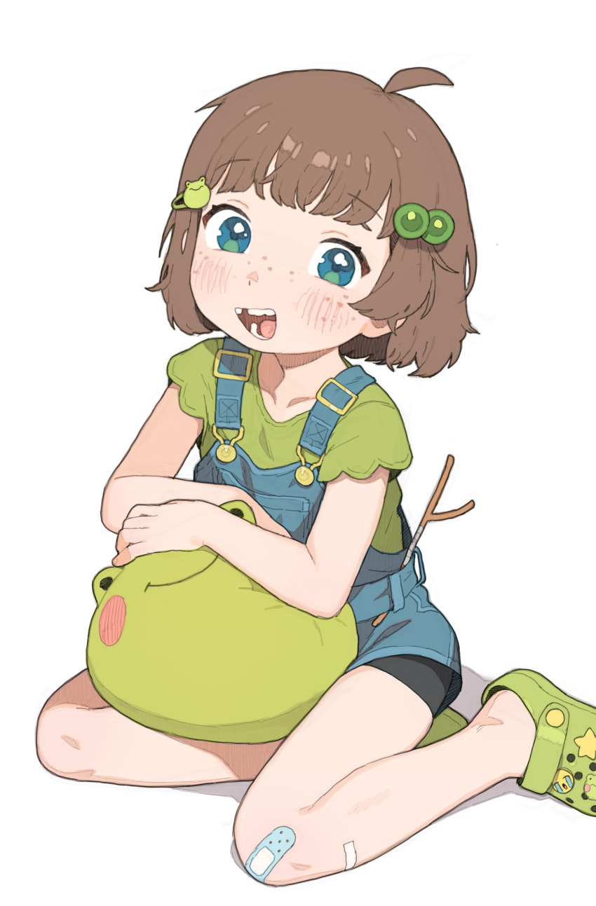 1girl absurdres ahoge aqua_eyes bandaid bandaid_on_knee bandaid_on_leg blue_overalls brown_hair child commentary crocs crying_emoji emoji english_commentary freckles frog_hair_ornament green_footwear green_shirt hair_bobbles hair_ornament highres indie_virtual_youtuber lily_hopkins looking_at_viewer missing_tooth open_mouth overalls paid_reward_available possummachine shirt short_hair short_sleeves sitting smile solo stuffed_animal stuffed_frog stuffed_toy t-shirt virtual_youtuber white_background