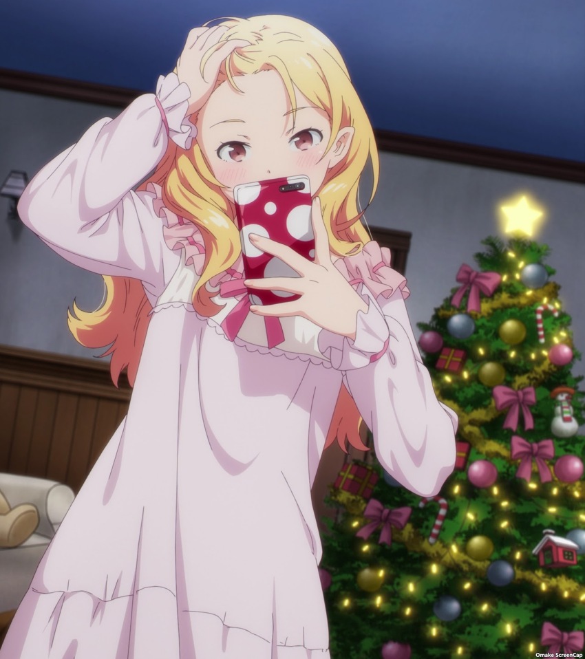 1girl a-1_pictures anime_screenshot blonde_hair brown_eyes candy candy_cane christmas_tree couch dot_nose eromanga_sensei food gift highres holding holding_phone indoors long_sleeves messy_hair nightgown phone photo_(object) pointy_ears selfie snowman standing star_(symbol) star_ornament stitched stuffed_animal stuffed_toy third-party_edit yamada_elf