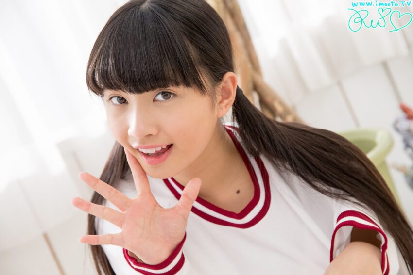 1girl arm_up black_hair braid brown_eyes grin hime_cut indoors japanese_(nationality) kuromiya_rei long_hair looking_at_viewer mole mole_on_neck open_hand photo_(medium) real_life smile teeth