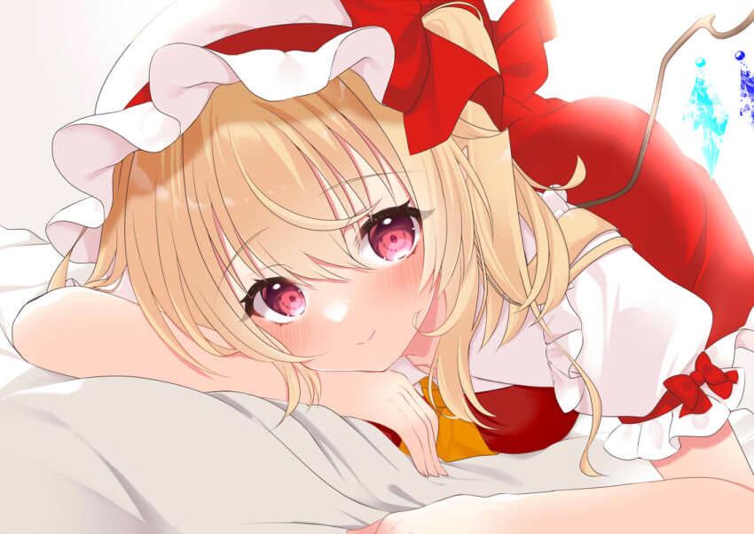 1girl ascot bed_sheet blonde_hair blush bow commentary_request crystal_wings dress feet_out_of_frame flandre_scarlet hat long_hair looking_at_viewer lying mob_cap on_stomach pink_eyes red_bow red_dress short_sleeves side_ponytail simple_background smile tosakaoil touhou white_background white_hat wings yellow_ascot