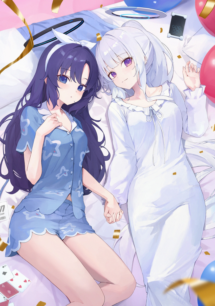 2girls absurdres bare_legs bed_sheet blue_archive blue_eyes blue_shirt blue_shorts blush card comiket_105 commentary_request confetti dress enokinoko1010 feet_out_of_frame grey_hair halo hand_grab highres interlocked_fingers light_smile long_hair looking_at_viewer lying multiple_girls noa_(blue_archive) on_back playing_card purple_eyes purple_hair shirt shorts streamers very_long_hair white_dress yuri yuuka_(blue_archive)