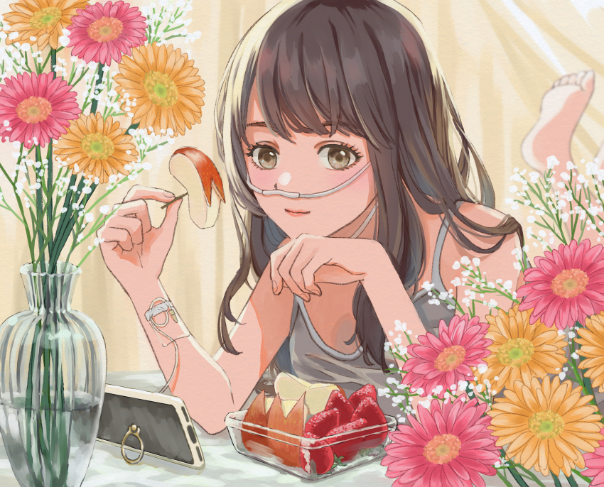 1girl absurdres apple_rabbit barefoot brown_eyes brown_hair cellphone flower food food_art fruit gucheng_jianglixiang hand_on_own_chin highres holding holding_food intravenous_drip long_hair looking_at_viewer lying nasal_cannula on_stomach original phone phone_stand smartphone smile strawberry tank_top vase