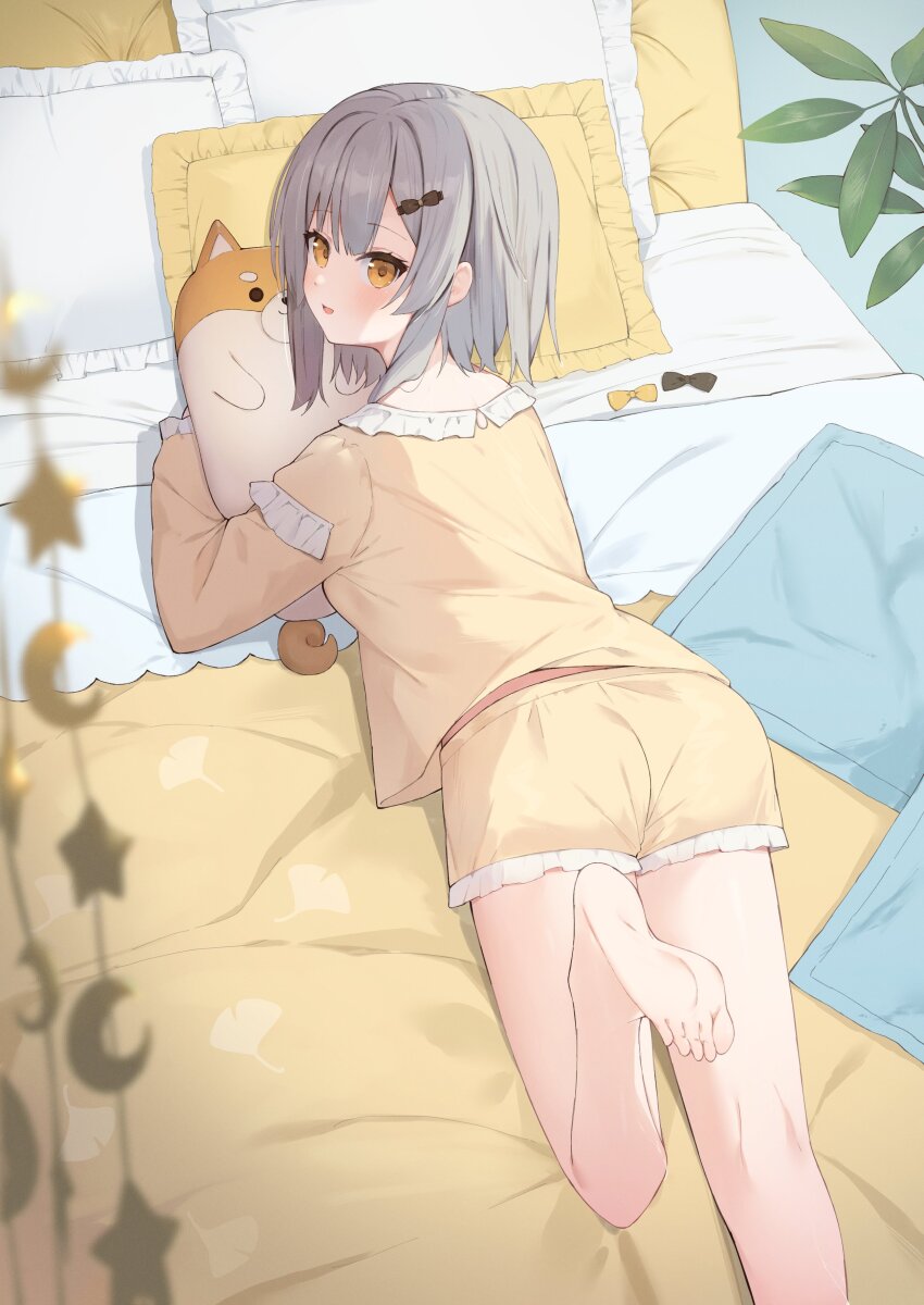 1girl absurdres barefoot bed feet foot_out_of_frame grey_hair highres leg_up legs looking_back lying mirai_(mirai76_) on_stomach open_mouth pillow plant production_kawaii shee_icho sleepwear soles solo stuffed_animal stuffed_dog stuffed_toy toes virtual_youtuber yellow_eyes