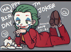  1boy animification batman_(series) cake dated dc_comics facepaint food food_on_face fork formal full_body green_eyes green_hair hair_slicked_back happy_birthday highres holding holding_fork jacket joker_(2019) long_hair long_sleeves lying male_focus moesaku6 on_stomach pants ringed_eyes smile smiley_face solo suit the_joker tongue tongue_out 