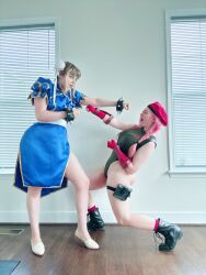  2girls ass bare_shoulders blue_eyes braid cammy_white cammy_white_(cosplay) capcom china_dress chinese_clothes chun-li chun-li_(cosplay) clenched_hands cosplay curvy double_bun dress fighting hair_bun hat highleg highleg_leotard highres huge_ass indoors jessicatalystic legs_apart leotard long_hair looking_at_another multiple_girls musclemommycosplay photo_(medium) pink_hair punching real_life shiny_clothes skindentation sleeveless smile street_fighter twin_braids wide_hips 