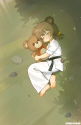  1girl ahoge animal_ears barefoot bear_ears bear_girl belt black_belt brown_fur chinese_commentary closed_mouth commentary_request dougi feet from_above full_body highres holding holding_stuffed_toy kuma-bound low_twintails lying martial_arts_belt on_grass on_side open_mouth original pants short_twintails sleeping soles solo stuffed_animal stuffed_toy teddy_bear toes twintails white_pants 
