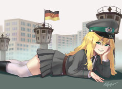  1girl aqua_eyes belt berlin_wall black_footwear black_necktie blonde_hair boots brown_belt building east_german east_german_flag fang feet_out_of_frame flag from_side giant giantess grey_jacket grey_skirt grey_sky hat highres jacket long_hair looking_at_viewer lying military military_uniform miniskirt mole mole_under_eye necktie on_stomach original outdoors peaked_cap pleated_skirt shirt signature skirt sky smile solo teaparty teeth thighhighs tower uniform white_shirt white_thighhighs 