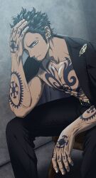  1boy alternate_costume armpit_hair armpit_hair_peek bara bare_pectorals black_hair dark-skinned_male dark_skin facial_hair feet_out_of_frame frown goatee hand_in_own_hair hand_tattoo highres jacket jacket_on_shoulders long_sideburns looking_at_viewer male_focus no_shirt one_piece pants pectorals pinattsu short_hair sideburns sitting solo suit_jacket tattoo toned toned_male trafalgar_law veins veiny_arms 