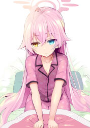  1girl ahoge blue_archive blue_eyes buttons closed_mouth hair_between_eyes halo highres hoshino_(blue_archive) long_hair pajamas pillow pink_hair pink_halo pink_pajamas polka_dot polka_dot_pajamas sen_(astronomy) short_sleeves solo yellow_eyes 