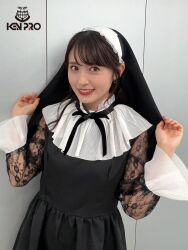  1girl aida_rikako costume indoors looking_at_viewer nun photo_(medium) smile standing voice_actor watermark 