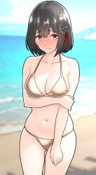  1girl alternate_costume arm_under_breasts bare_arms beach bikini black_hair blue_sky blurry blurry_background blush breasts brown_eyes cleavage closed_mouth cloud collarbone day embarrassed full-face_blush furaggu_(frag_0416) gold_bikini grabbing_own_arm haguro_(kancolle) hair_between_eyes hair_ornament highres kantai_collection large_breasts medium_breasts navel ocean outdoors short_hair sky solo standing swimsuit 