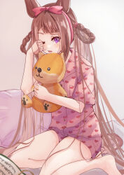  1girl alternate_costume animal_ears bed blush brown_hair hair_between_eyes hair_ornament hair_rings highres horse_ears horse_girl horse_tail long_hair looking_at_viewer notebook open_mouth pajamas pillow remoruto seiza sitting solo stuffed_animal stuffed_dog stuffed_toy sweep_tosho_(umamusume) tail umamusume white_background 