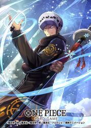  1boy black_coat coat commentary_request copyright_name cowboy_shot earrings hand_tattoo hat hokuyuu holding holding_sword holding_weapon jewelry long_coat looking_ahead male_focus official_art one_piece one_piece_card_game sideburns smile snowflakes solo sword tattoo trafalgar_law weapon wind 