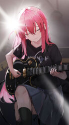  1girl absurdres black_shirt black_socks bocchi_the_rock! closed_eyes closed_mouth commentary commentary_request crossed_bangs cube_hair_ornament electric_guitar ema_(kuguiema) english_commentary gibson_les_paul gotoh_hitori grey_skirt guitar hair_intakes hair_ornament hair_over_shoulder head_tilt highres indoors instrument knee_up kneehighs long_hair mixed-language_commentary music pink_hair playing playing_guitar playing_instrument pleated_skirt shirt short_sleeves sidelocks sitting skirt smile socks solo 