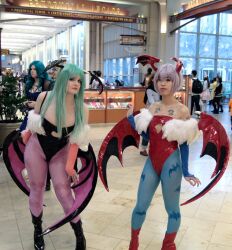  2girls breasts capcom cleavage cosplay green_hair lilith_aensland lilith_aensland_(cosplay) medium_breasts morrigan_aensland morrigan_aensland_(cosplay) multiple_girls photo_(medium) pink_hair small_breasts tattoo vampire_(game) wings  rating:Sensitive score:7 user:jthec