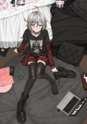  1girl :o absurdres ahoge bed belt black_footwear black_shirt blush boots cellphone choker commission computer dakimakura_(object) doll earbuds earphones feet grey_hair highres jewelry laptop layered_shirt lobotomy_corporation lobotomy_corporation_logo lobsteranian long_hair looking_at_viewer looking_up no_shoes on_floor open_mouth original phone pillow plaid plaid_skirt print_shirt project_moon punk red_eyes red_hair red_skirt ring shirt shoes short_hair sitting skirt socks solo striped_clothes striped_shirt striped_sleeves stuffed_toy t-shirt thighhighs torn_clothes torn_thighhighs unworn_shoes 