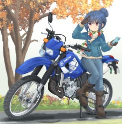  1girl autumn_leaves black_gloves blue_hair blue_jacket blue_pants boots brown_footwear cellphone commentary_request denim denim_jacket dirt_bike gloves hair_bun highres holding holding_phone jacket jeans logo looking_to_the_side mikeran_(mikelan) motor_vehicle motorcycle multicolored_clothes multicolored_scarf pants partial_commentary phone purple_eyes scarf shading_eyes shima_rin single_hair_bun smartphone solo standing standing_on_one_leg striped_clothes striped_scarf tree white_background yamaha yurucamp 