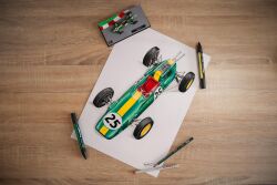  absurdres art_tools_in_frame car colored_pencil colored_pencil_(medium) commentary english_commentary formula_one goabascal highres lotus_(brand) lotus_25 marker marker_(medium) motor_vehicle no_humans pencil photo_(medium) shadow signature toy_car traditional_media vehicle_focus white_background 
