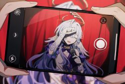  1girl 1other :d blue_hair blurry cellphone cellphone_photo closed_eyes depth_of_field detached_collar detached_sleeves dot_nose dress elbow_gloves facing_viewer gloves hair_between_eyes halo head_tilt head_wings holding holding_microphone honkai:_star_rail honkai_(series) inagoinaire long_hair microphone open_mouth phone pov pov_hands purple_sleeves red_curtains robin_(honkai:_star_rail) short_sleeves shy smartphone smile solo_focus strapless strapless_dress taking_picture upper_body viewfinder white_dress white_gloves wings 