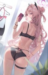  1girl ass back black_bra black_hairband black_panties blue_archive blush bra bracelet cellphone cellphone_charm charm_(object) clothes_hanger commentary_request cowboy_shot earrings fake_horns from_behind grin gyaru hair_bun hairband halo heart highres holding holding_phone horns houraku jewelry kirara_(blue_archive) long_hair looking_at_viewer looking_back panties phone pink_eyes pink_hair pink_nails selfie skindentation smartphone smile solo strap_slip thigh_strap underwear unworn_clothes v very_long_hair wavy_hair 