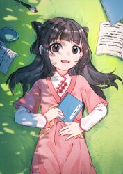  1girl :d absurdres black_hair blunt_bangs book brown_eyes chinese_clothes day dress grass hand_on_own_stomach hanfu highres holding jiang_an_an_(up_in_the_heaven) jiaoling_ruqun layered_sleeves long_hair long_sleeves looking_at_viewer lying on_back on_ground open_book open_mouth outdoors paintbrush paper pink_dress short_sleeves shuangyaji smile solo 