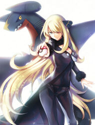  1girl alternate_eye_color black_coat black_pants black_shirt blonde_hair blue_eyes breasts cleavage closed_mouth coat commentary_request creatures_(company) cynthia_(pokemon) floating_hair fur-trimmed_coat fur_trim game_freak garchomp gen_4_pokemon hair_ornament hair_over_one_eye highres holding holding_poke_ball large_breasts long_hair long_sleeves mintes nintendo outstretched_arm pants poke_ball poke_ball_(basic) pokemon pokemon_(creature) pokemon_dppt revision shirt smile 