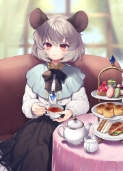  1girl animal_ears black_ribbon blue_capelet capelet center_frills commentary_request couch cream crystal_necklace cup food frills grey_hair grey_skirt highres long_sleeves macaron mouse_ears muffin nazrin neck_ribbon puffy_sleeves red_eyes ribbon sandwiched shirt short_hair sitting skirt solo teacup teapot tomobe_kinuko touhou white_shirt window 