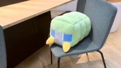 blue_eyes chair charjabug creatures_(company) game_freak gen_7_pokemon nintendo no_humans official_art photo_(medium) pokemon pokemon_(creature) solo spikes stuffed_toy table