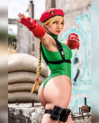 Rule 34 | 1girl, armpits, ass, blonde hair, braid, breasts, cammy white, cammy white (cosplay), cosplay, curvy, fingerless gloves, from behind, gloves, green leotard, hat, highleg, highleg leotard, highres, huge ass, large breasts, leotard, long hair, photo (medium), real life, rociomadariagaa, shiny skin, skindentation, sleeveless, street fighter, thong leotard, twin braids, very long hair, wide hips