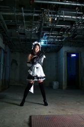 Rule 34 | 1girl, asian, assault rifle, cosplay, cosplay photo, gun, indoors, m4 carbine, maid, photo (medium), rifle, smile, solo, standing, thighhighs, weapon