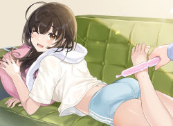 Rule 34 | 1girl, ;d, ahoge, ass, barefoot, blue shorts, brown eyes, brown hair, couch, holding, leg up, long hair, looking at viewer, lying, midriff, on couch, on stomach, one eye closed, open mouth, original, phone, pillow, shirt, short shorts, short sleeves, shorts, smile, solo, sweatdrop, tan (tangent), textless version, towel, towel around neck, tupet, white shirt