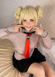 Rule 34 | 1girl, blonde hair, boku no hero academia, cosplay, looking at viewer, makeup, necktie, photo (medium), real life, school uniform, sitting, skirt, smile, solo, source request, sweetie fox, toga himiko, toga himiko (cosplay)