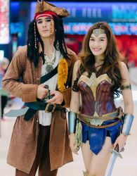 Rule 34 | 1boy, 1girl, asian, black hair, cosplay, costume, dc comics, hat, holding, holding sword, holding weapon, jack sparrow, jack sparrow (cosplay), photo (medium), pirates of the caribbean, sword, weapon, wonder woman, wonder woman (cosplay), wonder woman (series)