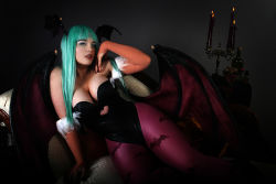 Rule 34 | breasts, candle, capcom, cleavage, cosplay, cosplay photo, couch, dark, demon girl, elbow gloves, freckles, gloves, green eyes, green hair, head wings, large breasts, lindze, lips, lipstick, long hair, makeup, morrigan aensland, morrigan aensland (cosplay), pantyhose, photo (medium), solo, vampire (game), wings