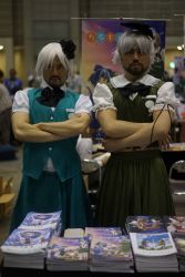 Rule 34 | 2boys, asian, beard, black neckwear, blue skirt, blue vest, blurry, blurry background, bow, bowtie, breast pocket, closed mouth, commentary request, convention, cosplay, cosplay photo, crossdressing, crossed arms, depth of field, facial hair, goatee, green skirt, green vest, hairband, highres, konpaku youmu, konpaku youmu (cosplay), looking at viewer, male focus, manga (object), manly, mitsuki yuuya, multiple boys, photo (medium), pocket, real life, short sleeves, skirt, touhou, vest, white hair