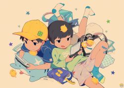 Rule 34 | 2boys, backpack, bag, bandaid, bird, black eyes, black hair, blue shirt, brown shorts, chick, commentary, english commentary, game console, green shirt, half-closed eyes, handheld game console, holding, holding handheld game console, lying, male focus, multiple boys, nintendo ds, no shoes, noeyebrow (mauve), on back, on stomach, open mouth, original, pink background, playing games, randoseru, school bag, shirt, shorts, socks, star (symbol), sticker, toy, video game, yellow headwear