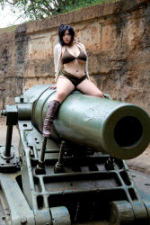 Rule 34 | belly, bikini, black hair, boots, breasts, camouflage, cannon, chouzuki maryou, hanging breasts, highres, hip focus, large breasts, looking at viewer, military, photo (medium), plump, side ponytail, sitting, swimsuit, thick thighs, thighs, underboob, wide hips