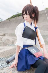 Rule 34 | 1girl, arm at side, black thighhighs, blue skirt, brown eyes, brown hair, closed mouth, cosplay, cosplay photo, day, japanese clothes, kaga (kancolle), kantai collection, kimono, lips, looking at viewer, muneate, outdoors, photo (medium), quiver, real life, serious, short hair, short sleeves, side ponytail, sitting, skirt, solo, thighhighs