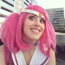 Rule 34 | city, cosplay, feli dragoon, hair ornament, league of legends, looking at viewer, lux (league of legends), open mouth, outdoors, photo (medium), pink hair, star (symbol), star guardian (league of legends), star guardian lux (cosplay), teeth, twintails, wig