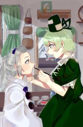 Rule 34 | 2girls, applying makeup, bangs pinned back, blurry, blurry background, blush, breasts, cowboy shot, cross-laced clothes, dress, from side, green curtains, green dress, green eyes, green hair, hand on another&#039;s chin, hat, highres, indoors, japanese clothes, kariginu, long hair, looking at another, makeup, mirror, mononobe no futo, multiple girls, no headwear, no headwear, oishiinori 1248, pom pom (clothes), ponytail, profile, short hair, silver hair, sitting, small breasts, soga no tojiko, tate eboshi, touhou, window